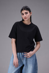 Female wearing a black Crew neck t-shirt regular fit and pants on a gray background
