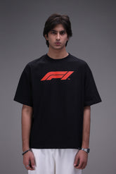 Male model wearing Boxy fit oversized Black Tee with Formula 1 logo in red.