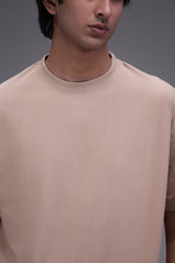 Man wearing a beige t-shirt showing fit fabric and detailling
