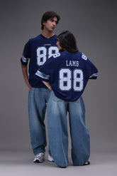 Two people wearing blue Dallas cowboys lamb 88 sports jerseys with the number 88.