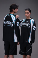 Two people wearing matching black mercedes formula 1 team sports outfits with Mercedes branding on a gray background