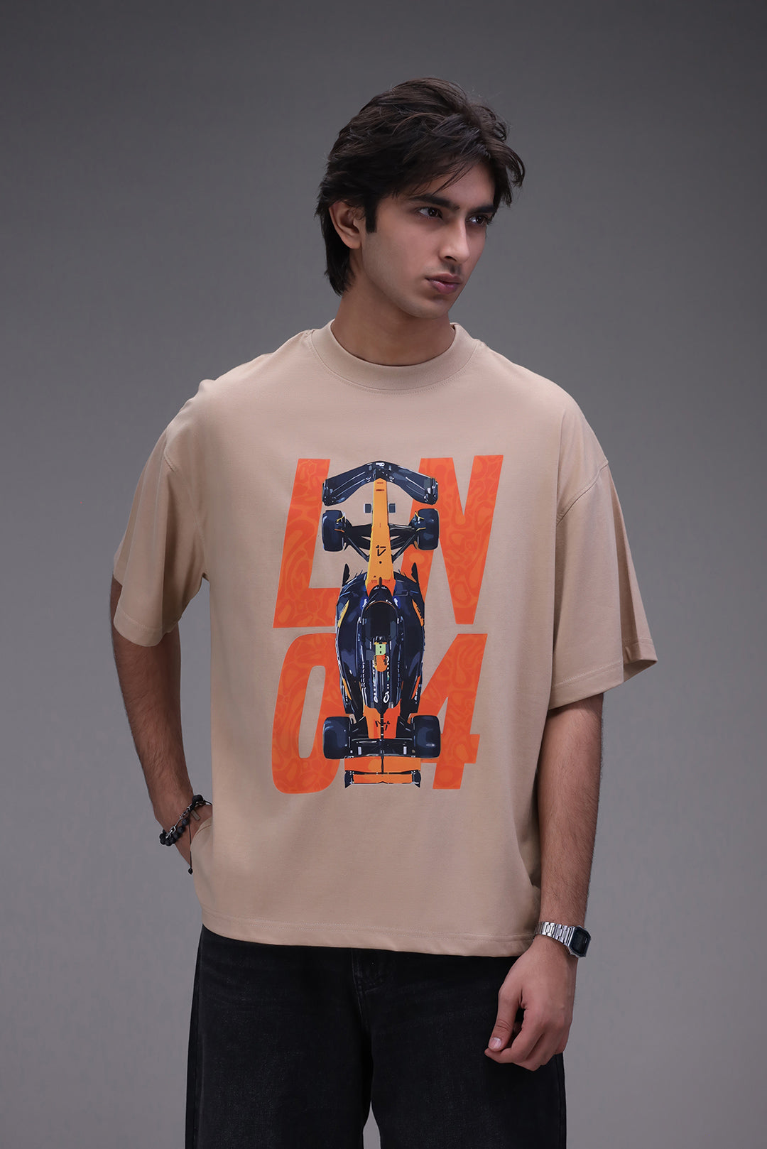 Man wearing a beige t-shirt with a Lando Norris formula 1 graphic design. 