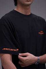 Person wearing a black McLaren t-shirt detailing