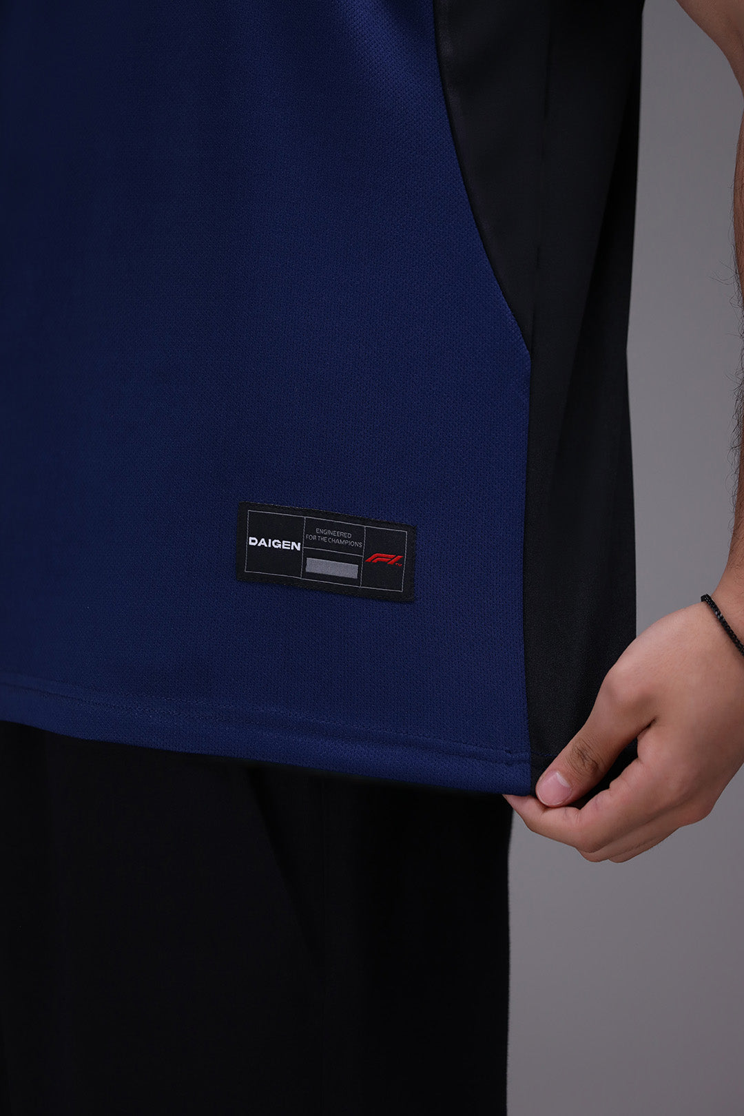 Close-up of a blue garment with a Daigen brand label on a gray background