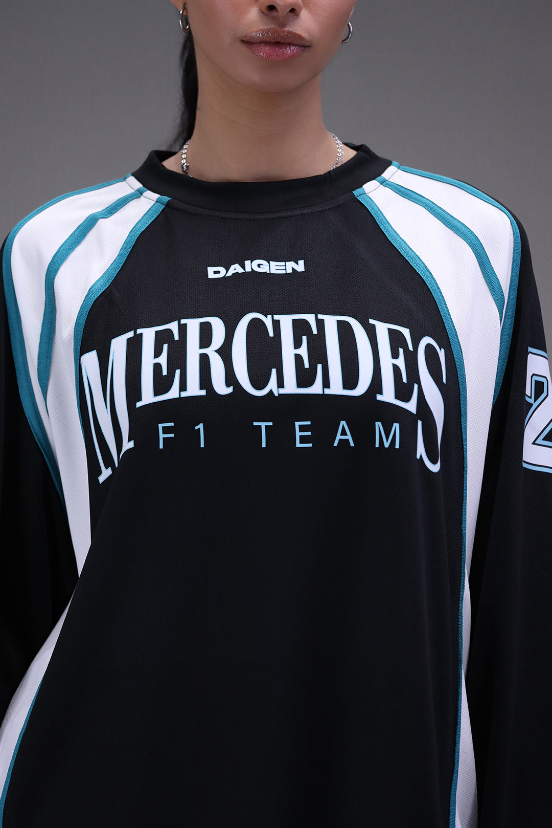 Mercedes jersey stitching and petronas green pannel detail close up