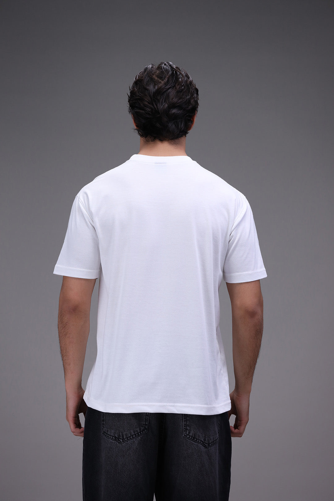 Person wearing a plain white t-shirt back
