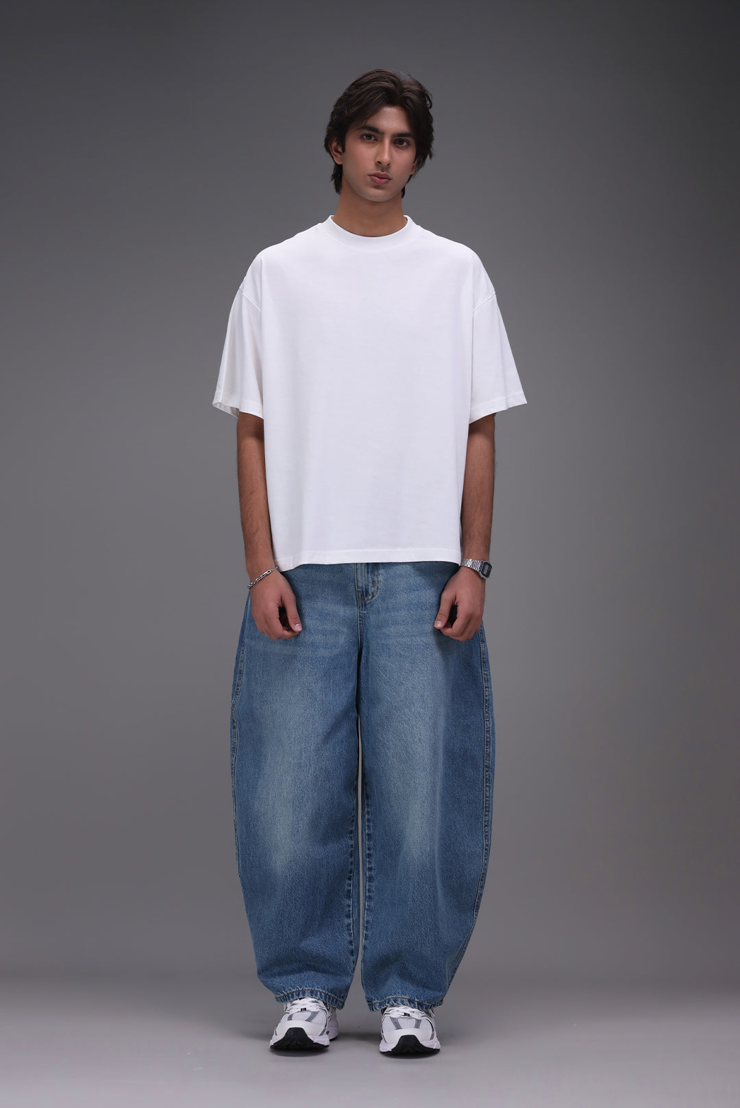 boxy fit t shirt front male wearing blue barrel fit denim with white oversized t-shirt Pakistan 