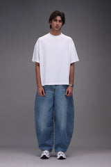 boxy fit t shirt front male wearing blue barrel fit denim with white oversized t-shirt Pakistan 